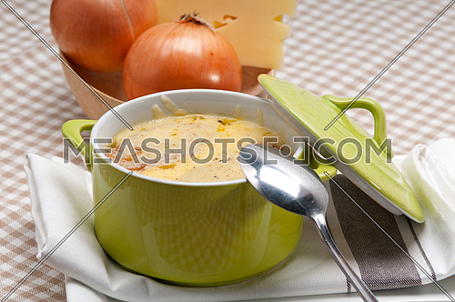onion soup on clay pot with melted cheese and bread on top