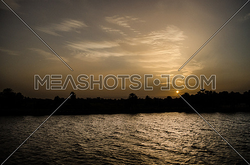 A silhouette of the Nile river during sun set