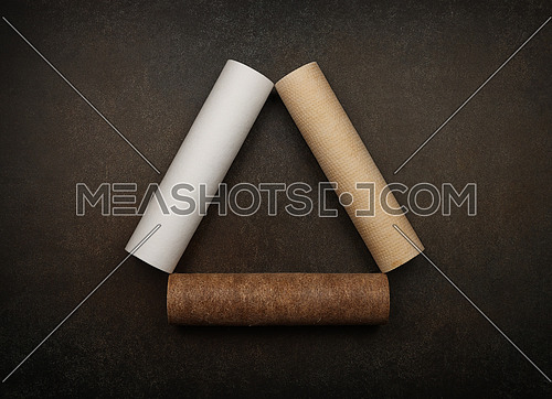 Close up three water purification filter cartridges, new clean and used dirty brown with rust after acute pollution and contamination of tap water, on grunge background