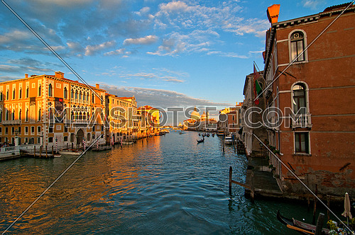 Venice Italy grand canal view from the top of Accademia bridge with "Madonna della Salute" church on background at sunset