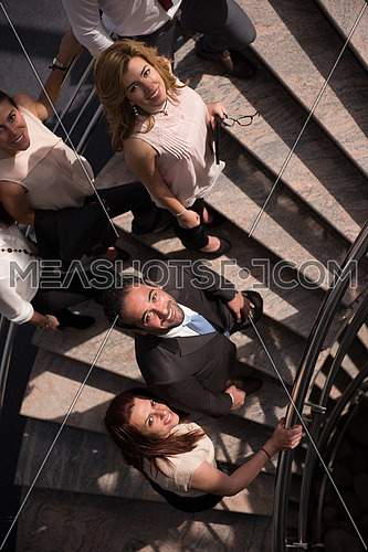 multi ethnic business people group asceding office stairs