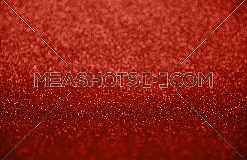 Abstract background of scarlet red bokeh defocused blurred lights and glitter sparkles