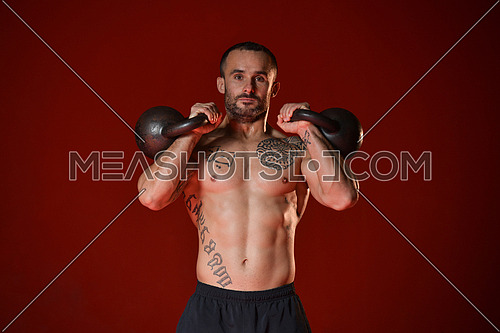 Young Man Working Out With Kettle Bell In A Gym - Bodybuilder Doing Heavy Weight Exercise With Kettle-bell