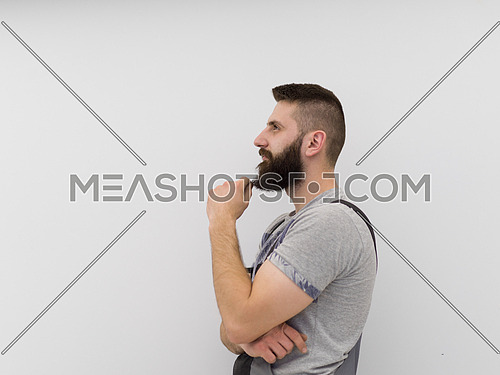 portrait of  young bearded hipster handyman isolated on white background