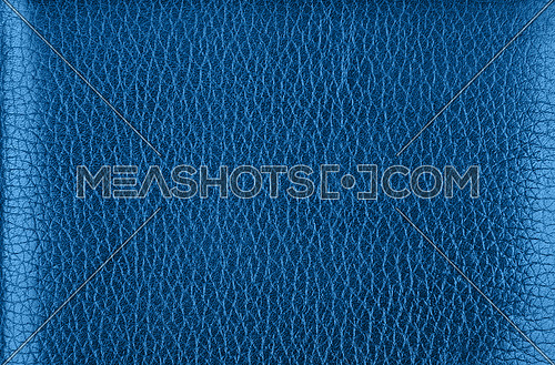 Close up background texture pattern of dark blue natural classic leather grain, directly above