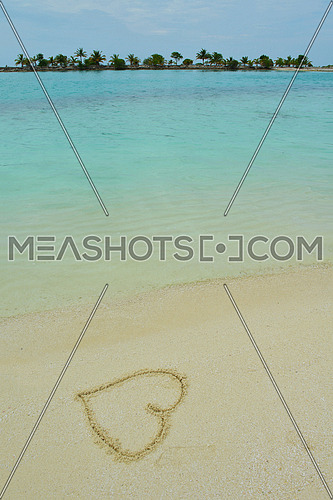 tropical beach nature landscape scene with white sand at summer with a heart shape on the sand