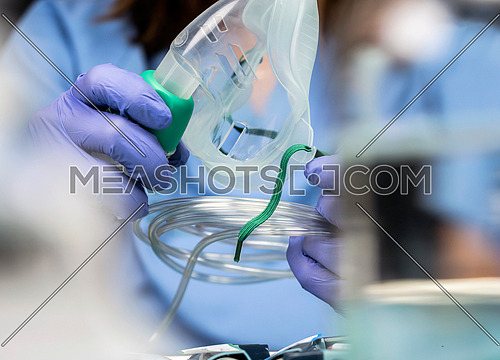 Nurse prepares oxygen mask in hospital, conceptual image