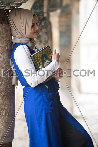 Humble Muslim Woman Is Reading The Koran Outdoors