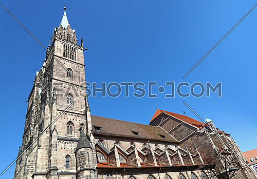 Saint Lawrence cathedral (St. Lorenz) over clear blue sky, medieval gothic church in Nuremberg, Germany, low angle side view