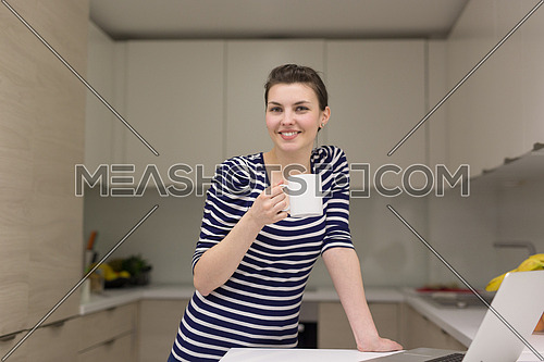 Real Woman Using laptop At Home Drinking Coffee Enjoying Relaxing