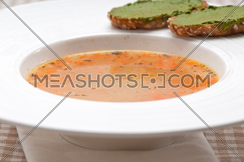 classic Italian minestrone " passato"soup with pesto crostini on side