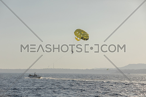 Long for for tourist parasailng in the Red Sea by day