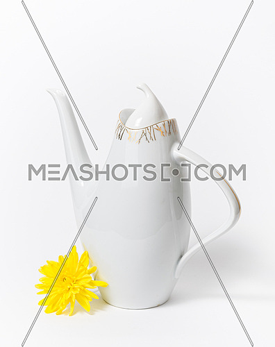 Czech ceramic white teapot and a yellow flower on white background, dating back to the 1960s