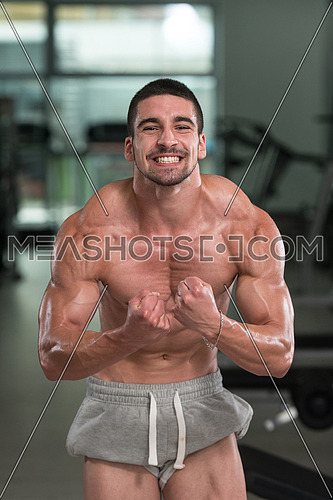 Awesome Bodybuilder Showing His Muscles And Posing In Gym