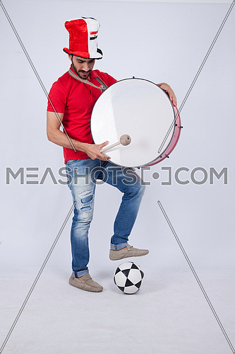 A young man holding big drums cheering on a white background