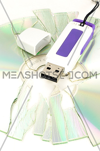 shattered cd and usb key on white background
