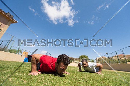 young middle eastern men athlete enjoys doing the extreme push-ups outside