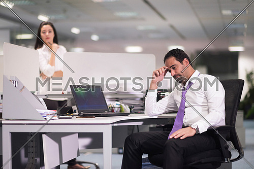 frustrated young business man working on desktop  computer at modern office