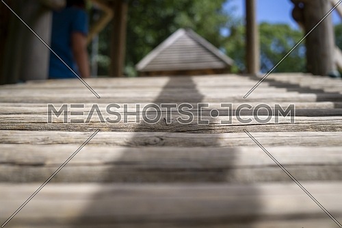 Natural wood climbing frame in a playground in a low angle view along the rungs in an outdoor setting