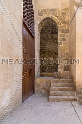 Stone staircase leading to vaulted entrance at stone bricks wall, Medieval Cairo, Egypt