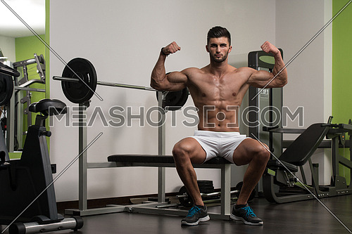 Portrait Of A Young Physically Fit Man Resting On Bench And Showing His Well Trained Body