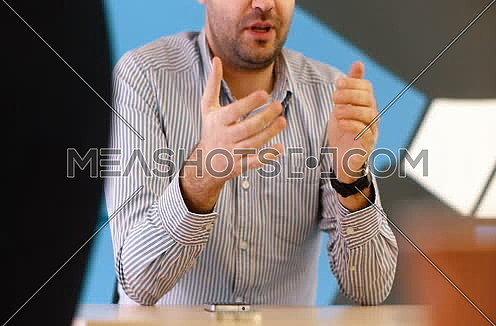 Business man using hands to explain business idea at strtup office