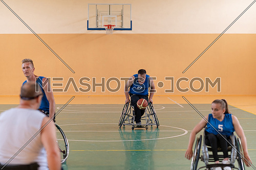 handicapped war veterans in wheelchairs with professional equipment play basketball matches in the hall. the concept of sports with disabilities. High quality photo