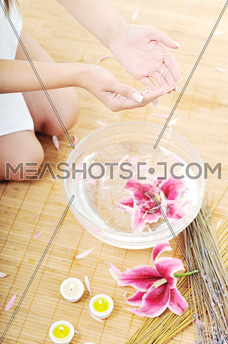 hand  and nail spa and beauty treatment with aroma and flowers in water isolated on white