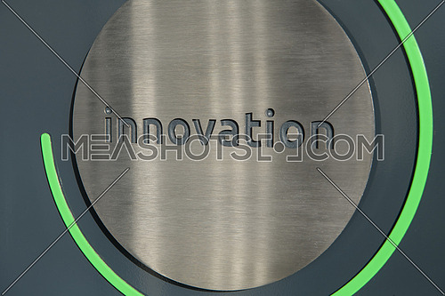 Engraving a CNC machine on a piece of metal. Engraving innovation text. High quality photo