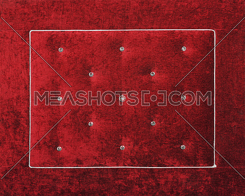 Close up background of dark red burgundy color soft velvet bed headboard with rhinestone crystals, front view