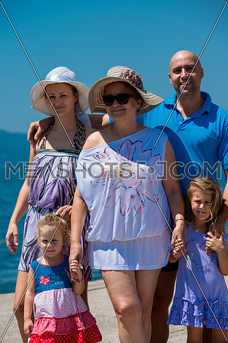 Portrait of happy multi generation family holding their hands while standing on the beach coast during Summer vacation Healthy family lifestyle concept