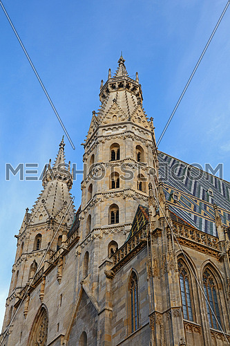 St Stephen Cathedral (Stephansdom) at Stephansplatz, the biggest cathedral and most important religious building in Vienna, Austria, over day blue sky, low angle view