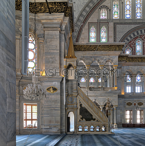 Interior shot of Nuruosmaniye Mosque, an Ottoman Baroque style mosque with minbar (platform), arches & colored stained glass windows located in Shemberlitash, Fatih district, Istanbul, Turkey