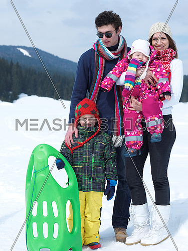 Winter playing, fun, snow and family portrait  sledding at winter time