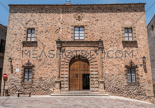Caceres, Spain - july 13, 2018: Episcopal Palace located in Plaza Santa Maria, main faÃ§ade, Renaissance style, has a half-point arch pontoon adorned by a double row of ashlars, Caceres, Spain