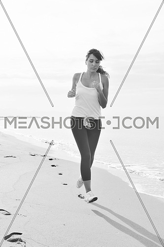 young healthy woman jogging and running at beach at early morning 
