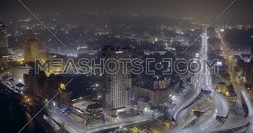 Aerial Shot flying towards the Hilton Hotel showing the River Nile, Bridge and Television Network Building in cairo at night
