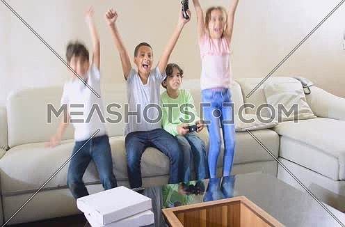 kids playing video games using joy sticks and game console