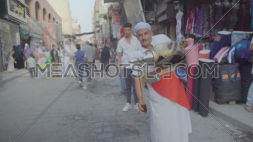 Fixed shot for Liquorice Juice seller in El Moez Street in Cairo at day