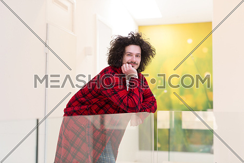 portrait of young man in bathrobe enjoying free time at home