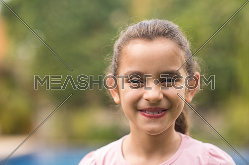 portrait of small middle eastern girl on a sunny summer day