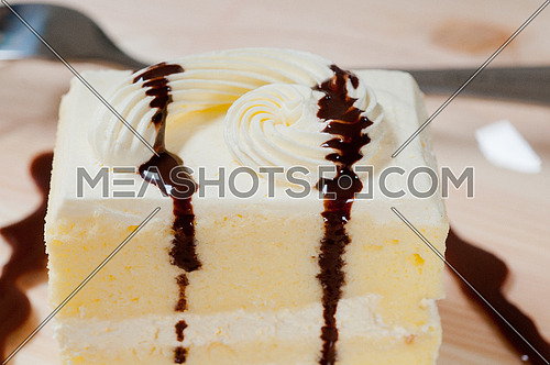 fresh cream cake closeup with chocolate sauce topping