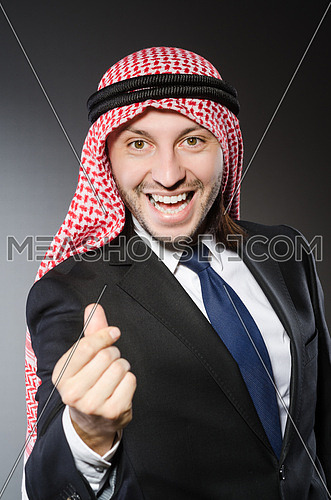 Arab businessman in delight against grey background