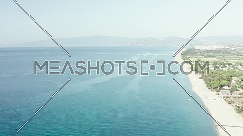 Aerial view of beautiful mediterranean sea and beach at sunny day, seascape and hill mountain on backgrond, Simeri Mare, Calabria, Southern Italy