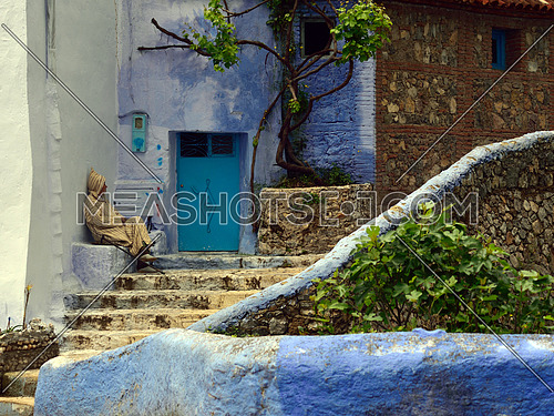an old man sitting in-front of door entrance