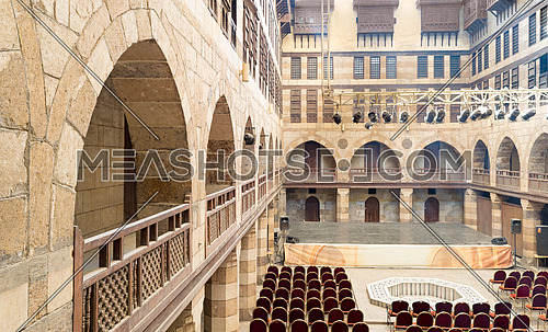 Courtyard of caravanserai (Wikala) of al-Ghuri, surrounded by two floors of vaulted arcades leading to storages rooms, and three floors of windows covered by interleaved wooden grids (mashrabiyya), suited in Tablita Street parallel to al-Azhar Street, Medieval Cairo, Egypt