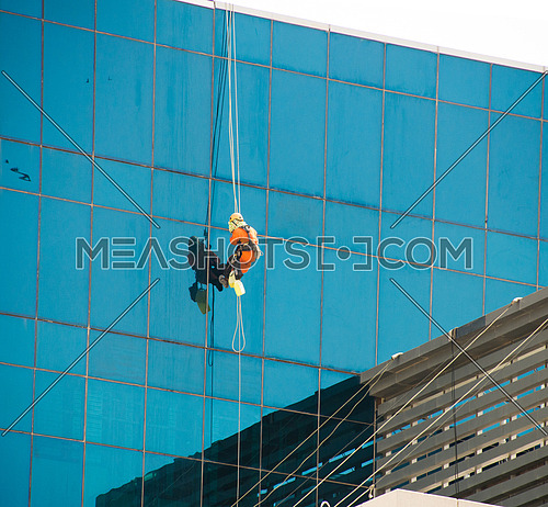 window cleaners on high skyscraper in dubai