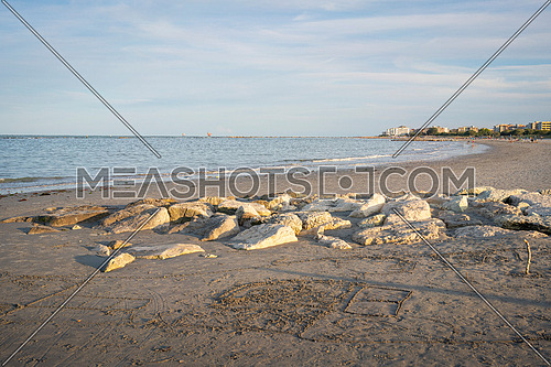 Landscape of sandy beach and rocks.Summer vacation concept.Lido Adriano town,Adriatic coast, Emilia Romagna,Italy.