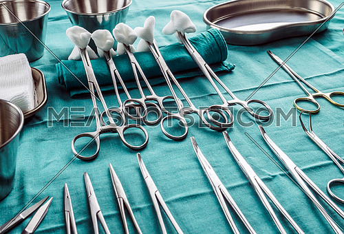 Scissors surgical with torundas in an operating theater, composition horizontal, conceptual image