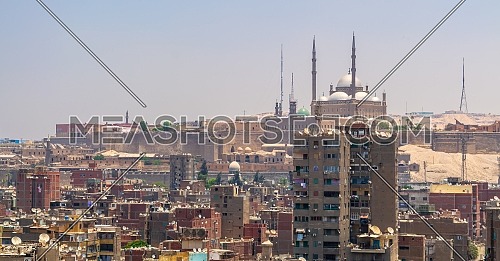 Aerial cityscape view of old Cairo, Egypt with old buildings and Citadel of Egypt in far distance from minaret of Ibn Tulun Mosque